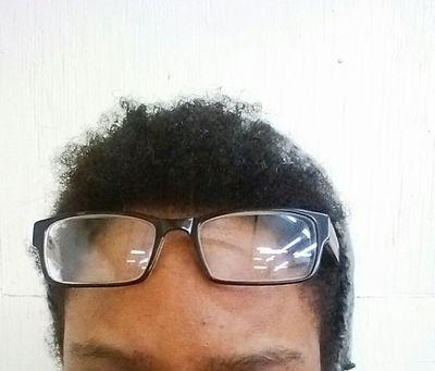 Talise Hendrix About Me Profile Picture. Shows black framed glasses sitting atop head